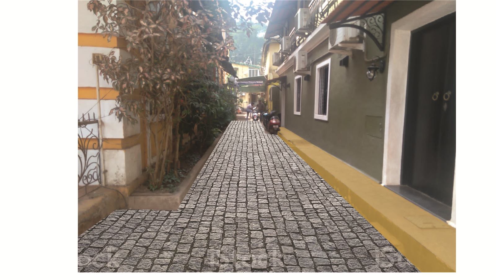 A cobbled heritage lane in Panaji with yellow-edged walls